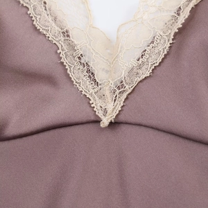 Detailed V-neck of a satin midi dress featuring delicate grey-purple fabric and lace trim
