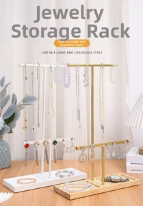 Detailed view of jewelry display stand featuring metal hanging bars and a wooden base tray
