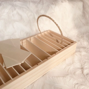 Macro view of wooden organizer slots with a pearl headband on white faux fur background