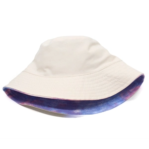 Detail of reversible tie-dye bucket hat showing stitching on the beige canvas side