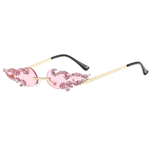 Frameless flame-shaped sunglasses with pink gradient lenses and rhinestone trim