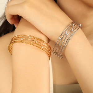 Minimalist 18K gold and silver plated C-shaped bangles with pearls on a model