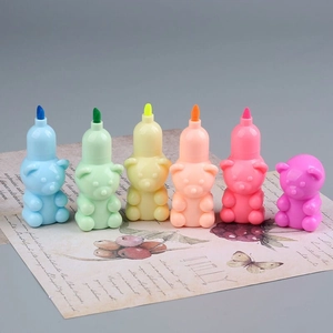 Set of 6 bear-shaped highlighters in multiple colors on decorative paper background