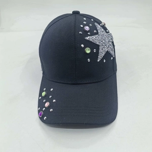 Detail of black cotton baseball cap featuring silver star embroidery and colorful rhinestones