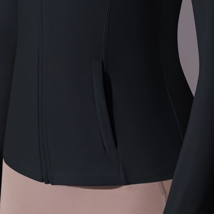 Detailed view of women's athletic jacket zipper and side pocket with reinforced stitching