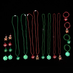Christmas jewelry set with Santa ornaments and glowing LED pendants on a black background