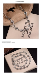 Detail of silver daisy necklace showing connected charms and adjustable extension chain