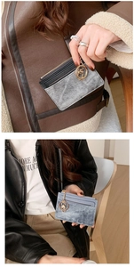 Detailed view of compact card holder with zipper pocket and golden key ring attachment