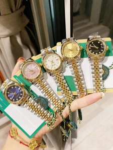 Detailed view of women's quartz watches with two-tone steel bands and vibrant colored dials