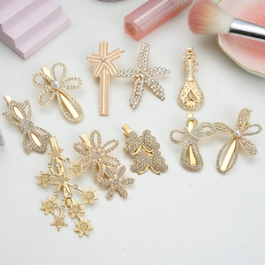 Set of 10 golden alloy hair clips with rhinestones and pearls on a vanity background