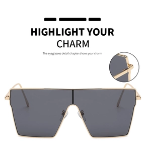 Detailed view of square metal sunglasses hinges with gold frame and grey lenses