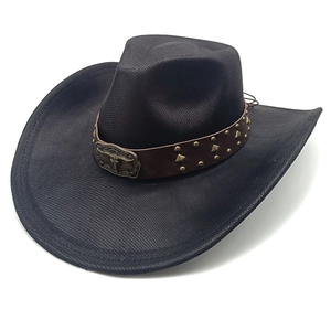 Detail of western cowboy hat with cattle head metal relief on studded leather band