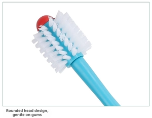 Close-up of dual-head pet toothbrush with rounded soft bristles for dog dental care