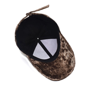 Detailed top view of brown velvet baseball cap showing adjustable strap and inner lining