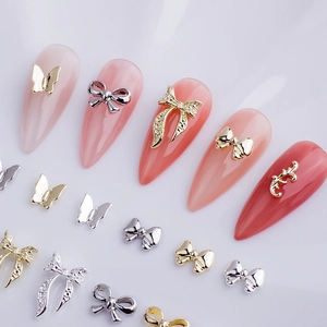 3D metallic bow and butterfly nail art charms in gold and silver with rhinestones