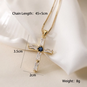 Macro shot of 18K gold plated cross necklace with blue zircon and size specifications
