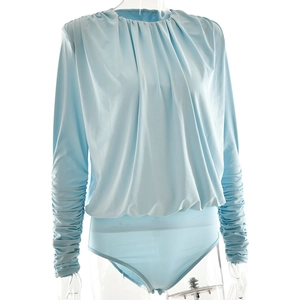 Detailed view of light blue bodysuit featuring draped ruched bodice and stacked sleeves