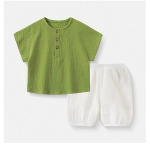 Close-up of cotton gauze kids' short sleeve set with wooden buttons and texture