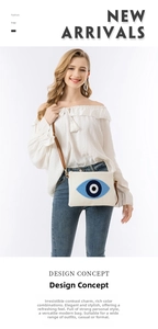 Detail der weißen Canvas-Clutch mit Nazar-Augen-Stickerei und braunem Lederriemen