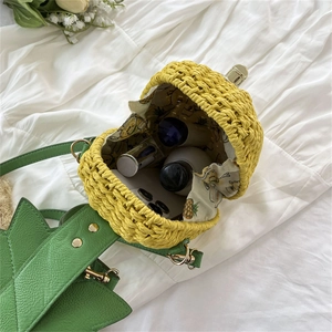 Handmade woven pineapple bucket bag with green leather leaves and floral lining