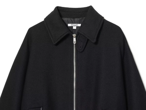 Detail shot of black casual jacket with silver metal zipper and brand size tag S