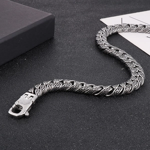 Macro shot of punk style titanium steel chain with vintage totem patterns and square buckle