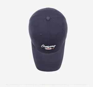 Close-up of Champions embroidery and athletic lettering on navy cotton baseball cap
