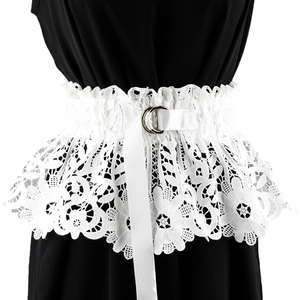 Close-up of white floral embroidery lace corset belt with double metal rings on black dress