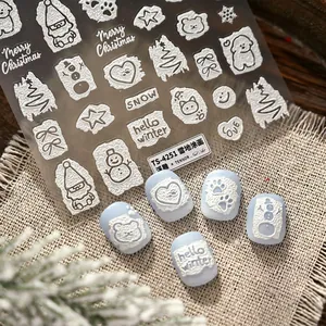 5D embossed Christmas nail stickers with white snowman and tree designs on blue nails
