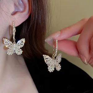 Luxury butterfly stud earrings with sparkling cubic zirconia and faux pearls on gold base
