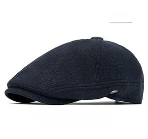 Detailed view of navy blue wool flat cap showing fine knit texture and metal side button