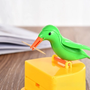 Cute bird shaped automatic toothpick dispenser in green and yellow with plastic base