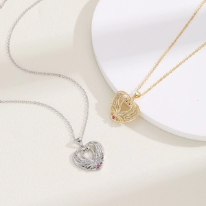 Elegant gold and silver heart necklaces with swan pendants and red gemstones