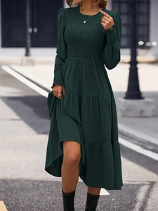 Elegant forest green tiered midi dress with smocked bodice and ruffled cuffs