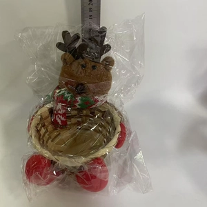 Detailed view of plush reindeer candy basket with hand-woven bamboo base and festive scarf