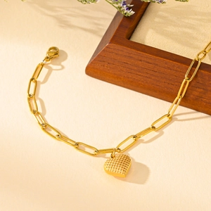 Elegant gold heart pendant bracelet with textured grid charm and paperclip chain