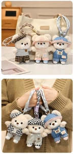 Detail of cute teddy bear plush pendants in trendy outfits attached to a beige tote bag