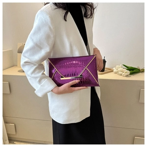 Detailed view of a purple crocodile pattern envelope clutch bag with gold metallic trim