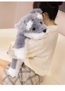 Plush Schnauzer dog long pillow shown held by a girl in a cozy home setting for scale