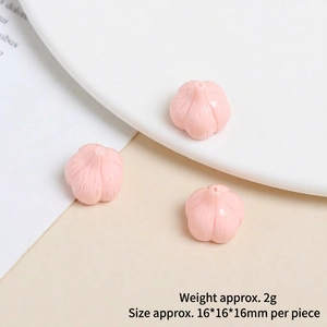 Close-up of mini pink resin garlic charm for DIY crafts, size 16x16mm, set of three pieces