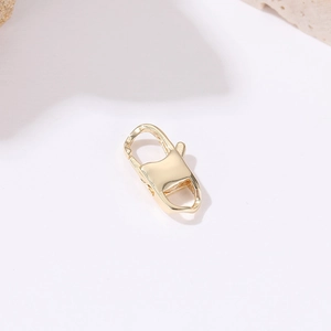 Detailed view of a polished 14k gold-plated heart lobster clasp for DIY jewelry making