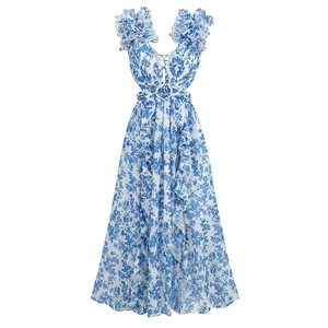 Detailed view of blue floral maxi dress with deep V-neck, waist cut-outs and ruffled hem