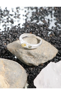 Macro shot of S925 sterling silver ring with yellow and olive green zircon stones