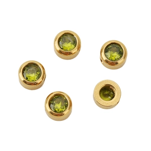 Detailed view of 6mm golden stainless steel beads inlaid with green faceted gemstones