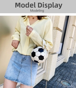Close-up of creative black and white soccer ball crossbody bag with gold chain strap