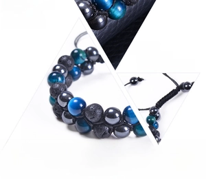 Macro detail of natural blue tiger eye and lava stone beads with adjustable braided cord
