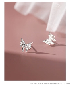 Macro shot of silver molten lava butterfly studs showing unique mirror metallic texture