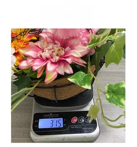 Detail shot showing the artificial hanging basket flower weight of 315g on a digital scale