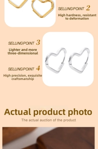 Detailed macro view of heart-shaped titanium steel hoop earrings in gold and silver finish