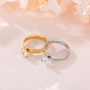 Detail of 4mm square zircon rings in gold and silver finish with classic claw setting